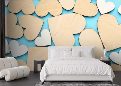 Brown and white wooden hearts on blue background Wall mural