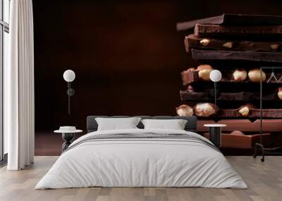 Chocolate pieces with hazelnuts on wooden table Wall mural