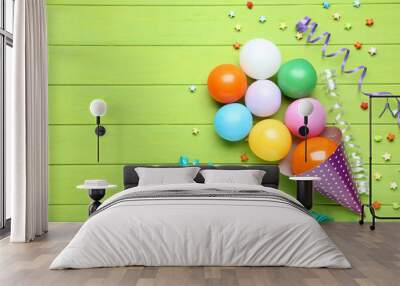 Colorful balloons with birthday cap and paper star on wooden table Wall mural