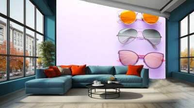 Colorful sunglasses on purple background Wall mural