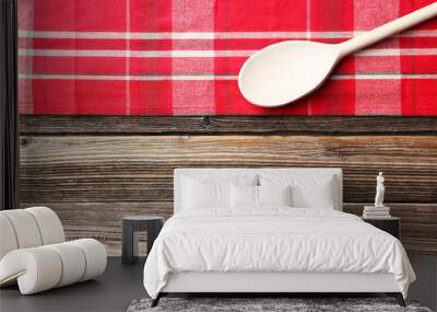 Empty wooden table with wooden spoon and napkin on brown backgro Wall mural