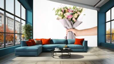 Female hand holding beautiful flower bouquet on white background Wall mural