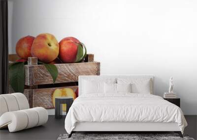 Fresh peaches in crate on white background Wall mural