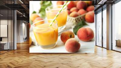 Glasses of peach juice on white wooden table Wall mural