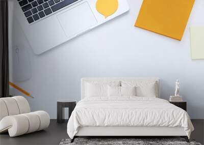 Laptop computer with office supplies on white background Wall mural