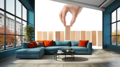 Male hand taking one wooden block on white background Wall mural