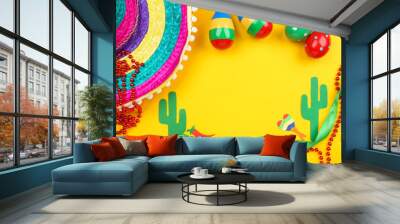 Mexican hat with maracas and paper cactuses on yellow background Wall mural