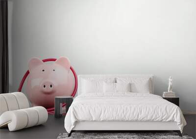 Pink piggy bank with stethoscope on wooden table Wall mural