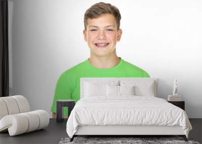 Portrait of young man with dental braces on white background Wall mural