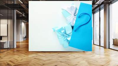 Shopping bag with gift boxes on grey background Wall mural