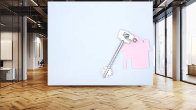 Silver key with paper house on grey background Wall mural