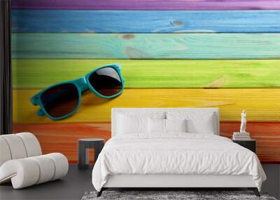 Sunglasses on a coloful wooden table Wall mural