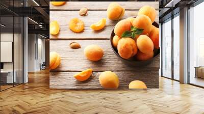 Sweet apricots in bowl on grey wooden table Wall mural