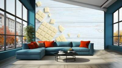 White chocolate pieces on wooden table Wall mural