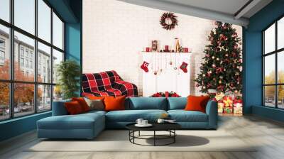 White decorated fireplace near sofa and christmas tree on brick wall background Wall mural