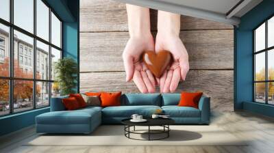 Woman's hands with chocolate heart Wall mural