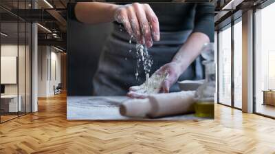 Woman baker with flour in her hands Wall mural