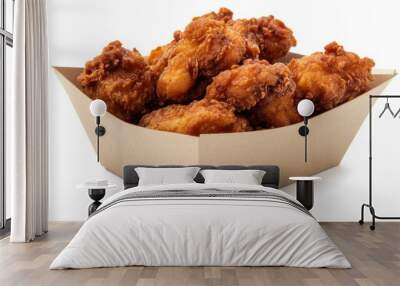 Deliciously crispy, spicy fried chicken pieces in a paper box, isolated on a white background, ready to enjoy Wall mural