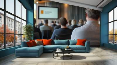 Engaged audience in a business presentation, seen from behind a professional in a modern conference room Wall mural