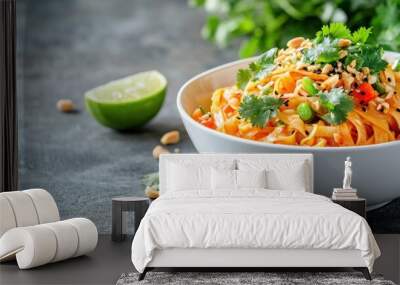 Freshly made vegetarian Pad Thai in a clean white bowl, garnished with lime, cilantro, and peanuts, isolated on a minimalist background with copy space Wall mural