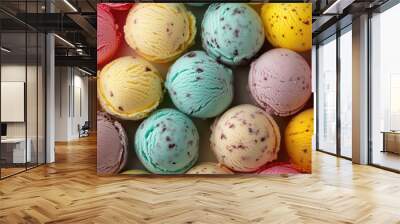 Multiple scoops of different colored ice cream balls, top view, forming a delightful background. Wall mural