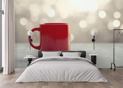 Simulated red coffee mug on a minimalist white background with bokeh light effects, a cozy design scenario. Wall mural