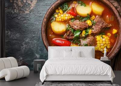 Top view of a delicious bowl of Colombian sancocho, a hearty soup with meat, corn, and potatoes, with space for copy. Wall mural