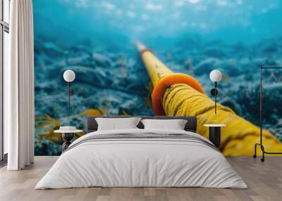 Vividly colored yellow and orange undersea cables traversing the ocean floor, representing global communication and underwater technology. Wall mural