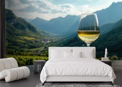 White wine glass on a wooden table with green mountains in the background, ideal for capturing nature and luxury. Wall mural