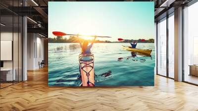 People kayak during sunset in the background. Have fun in your free time. Wall mural