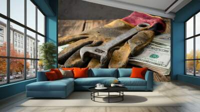 wrench, old tools and dirty gloves with banknotes, laboulers century, empty space Wall mural