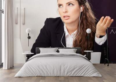 stressed out business woman with headset earphones angry concentrated in conference call Wall mural