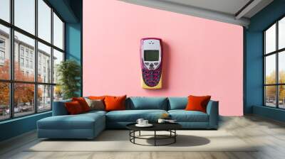 Retro mobile push-button telephone on a pink background. Wall mural