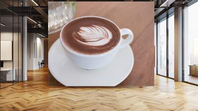 hot chocolate drink with leaf latte art. cocoa beverage on wood table. Wall mural