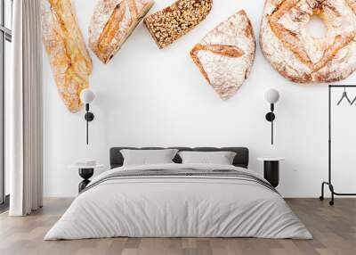 Bread shop. Baker's shop. Assorted bread on white background top view space for text Wall mural