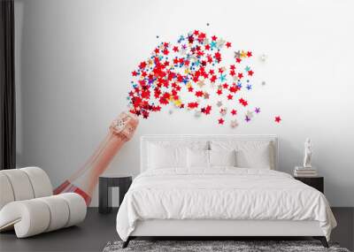 Champagne bottle with colorful party streamers for celebration on white background top view mock up Wall mural