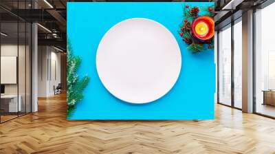 Christmas table setting with gift box and fir tree blue background top view mockup Wall mural