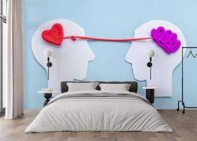 Communication and relationship concept - brain and heart on two paper human heads Wall mural