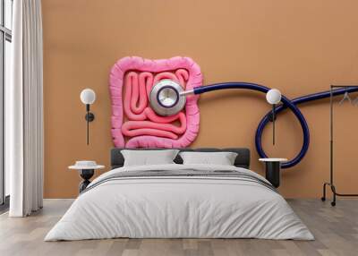 Digestive colon system health concept. Intestines shape made of plasticine with stethoscope Wall mural