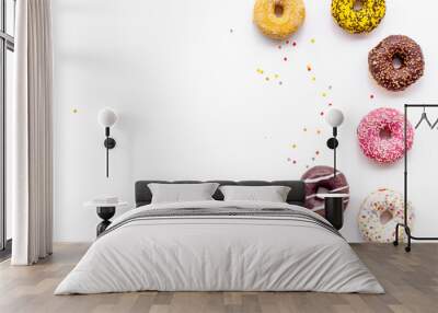 Donuts of different flavors for breakfast on white background top view Wall mural