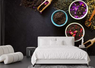 Dry leaves of herbal tea frame on black background top view mock-up Wall mural