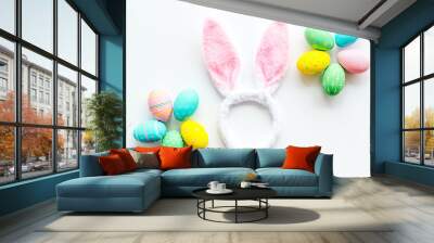 Easter symbols. Bunny and painted eggs on white background top-down Wall mural