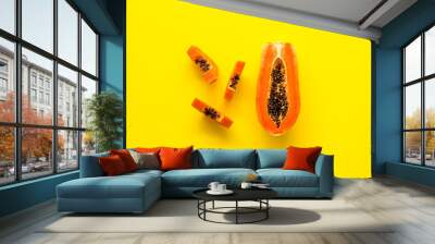 Exotic fruit. Papaya slises on yellow background top view copy space Wall mural