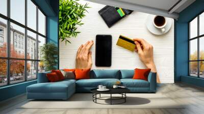 Female hands with mobile phone and credit card - online banking and shopping Wall mural