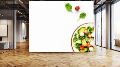 Fresh salad with mozzarella, spinach, cherry tomatoes, cucumber on plate on white background top view copy space Wall mural