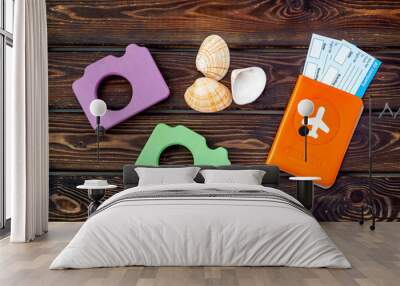 Funny vocation concept with camera, passport and tickets on wooden background top view Wall mural