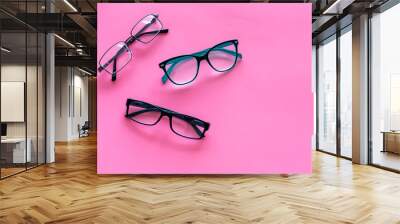 Glasses concept. Set of glasses with different eyeglass frame and transparent lenses on pink background top view copy space Wall mural