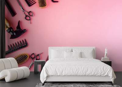 Hairdressing instruments. Combs, scissors on pink table top view frame copy space Wall mural