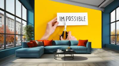 Hands changing word impossible to possible with scissors. Selfmade concept Wall mural