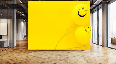 Happiness emotion. Yellow balloon with smile on yellow background top view space for text Wall mural